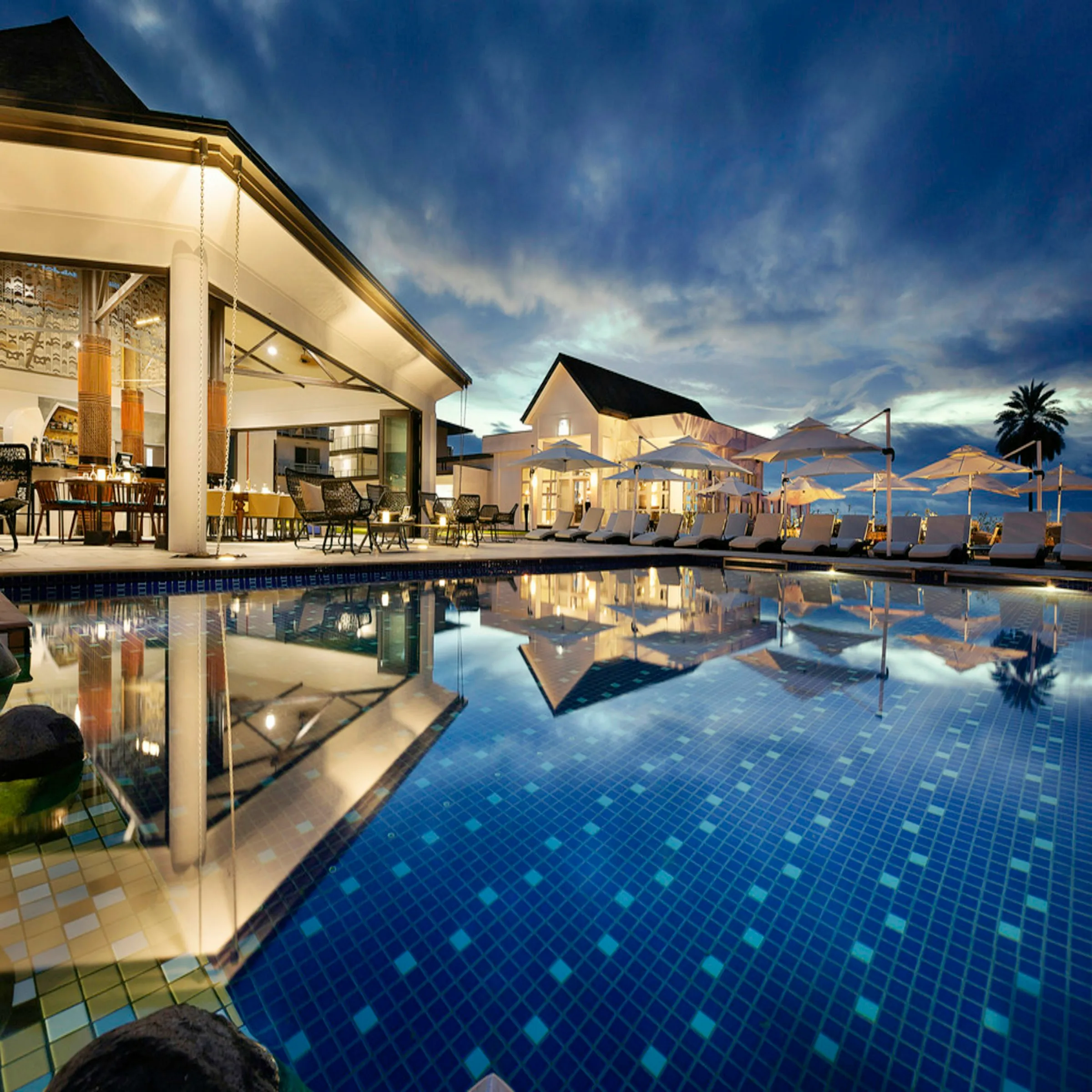 Candlelit courtyard pool at an Atlas hotel after dark