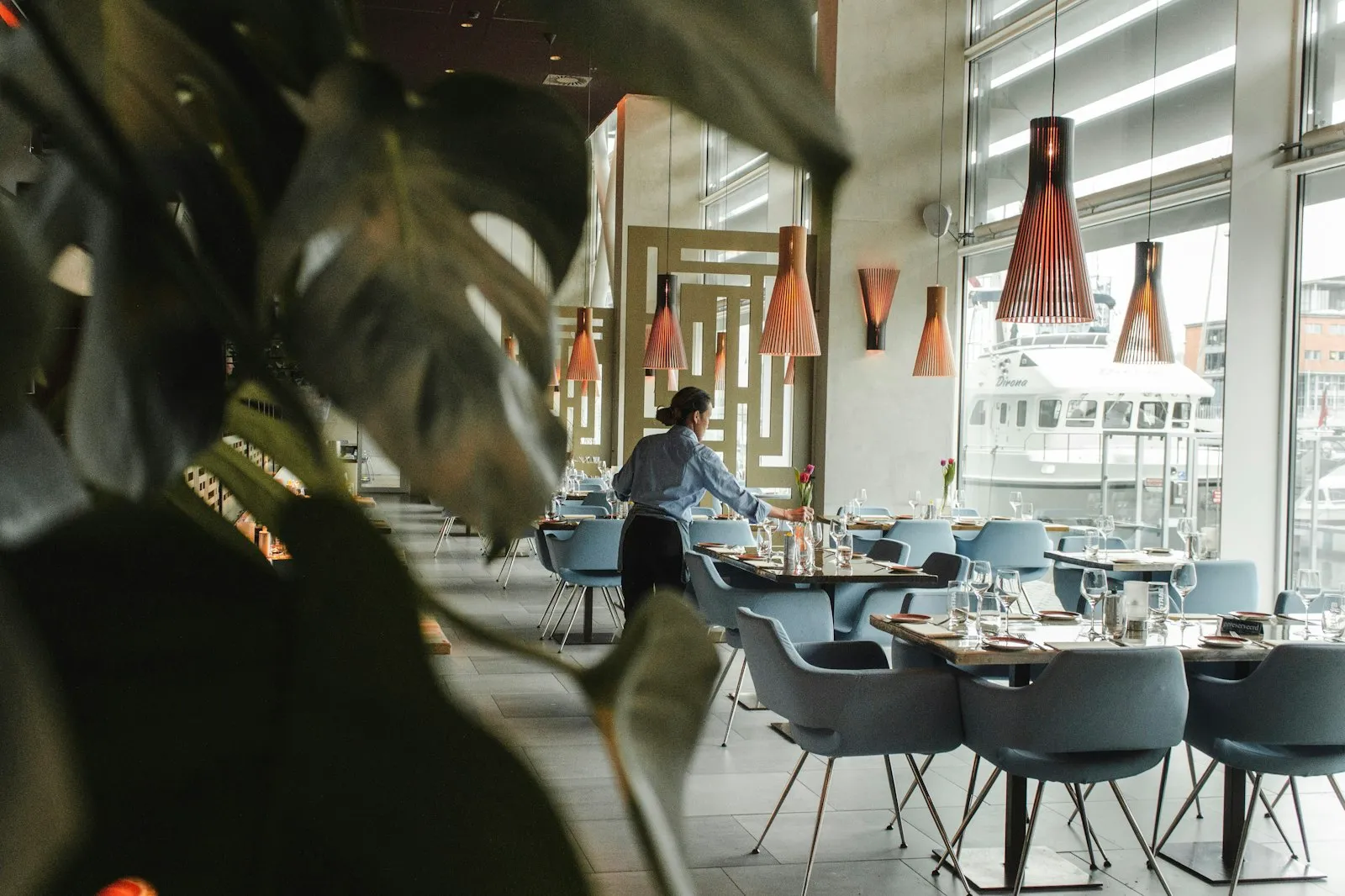Quiet hotel dining room with pendant lamps